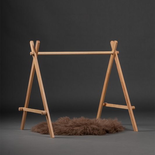 wooden baby floor gym frame with a designed to support hanging toys for sensory and motor development in infants