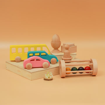 A colorful Montessori kit featuring wooden vehicles, rattles and sensory toys for children above 6 months