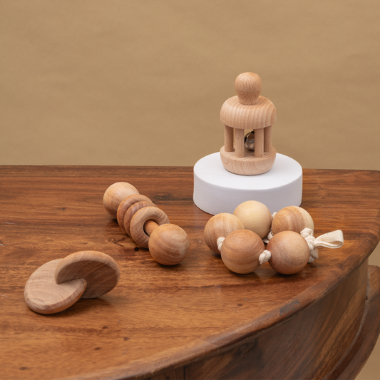 Wooden Baby Toys – a set of hand-crafted wooden rattles, interlocking discs, and grasping beads – designed for sensory stimulation, grasp development, and early motor skills in babies