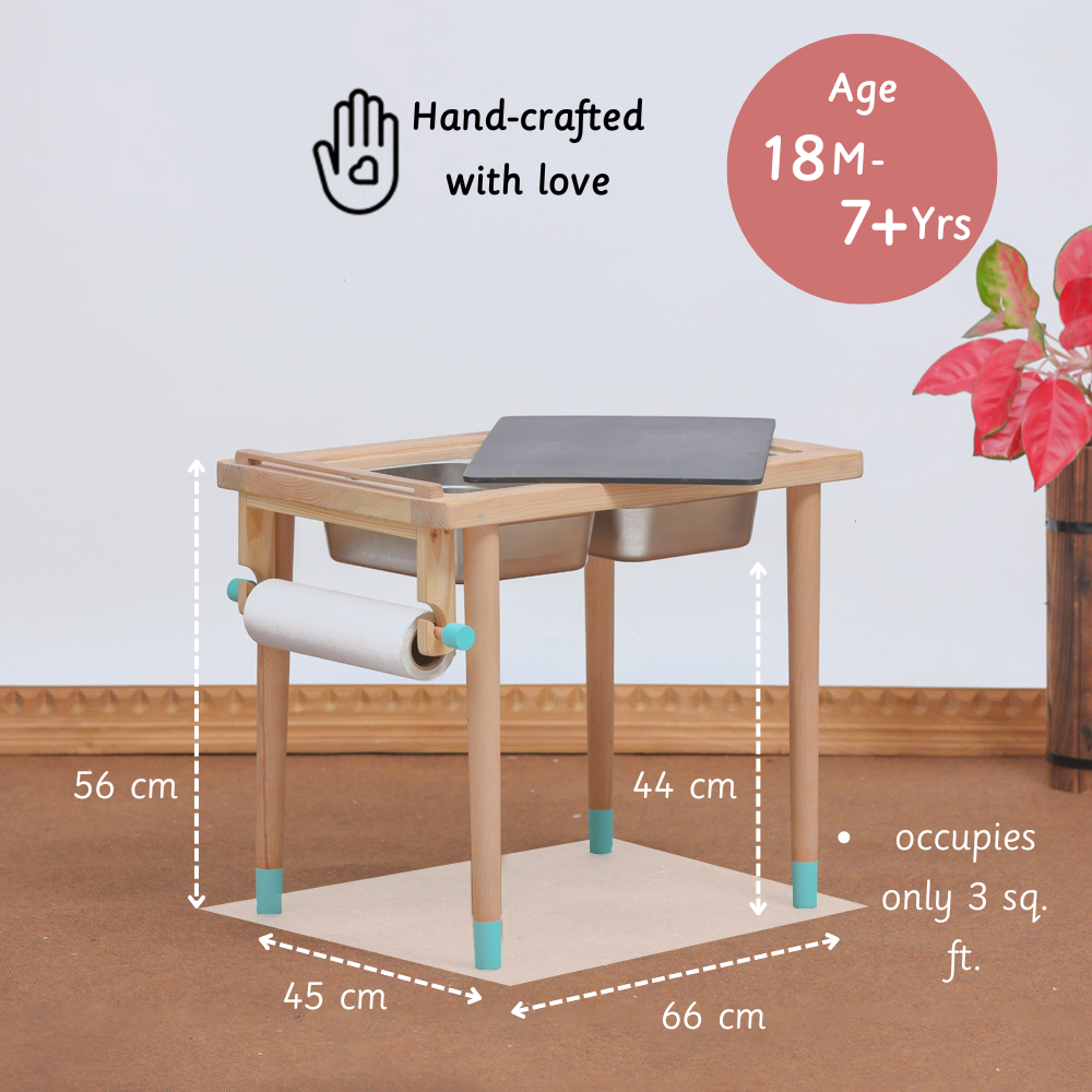 A hand-crafted, foldable sensory table for kids aged 18 months to 7+ years, featuring a blackboard top, dual stainless steel bins, and a built-in art paper roll—perfect for creative play in just 3 sq. ft. of space.