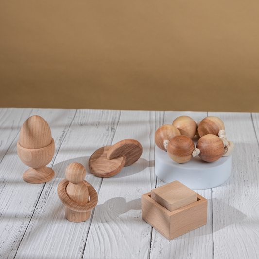 Wooden Montessori Toys ,handcrafted natural wood toys including shapes, figures, and beads arranged for toddler sensory and developmental play.