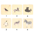 six square wooden puzzle or book pages, each featuring a different animal illustration—a puffin, a penguin, a dalmatian, a husky, a black panther, and a zebra