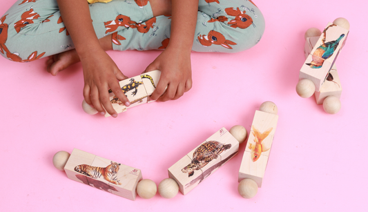 Child playing with the Ariro wooden rotating puzzle