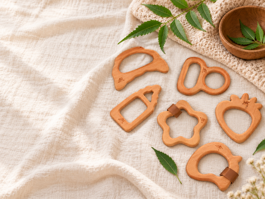 Neem wood teethers arranged on natural cloth with neem leaves