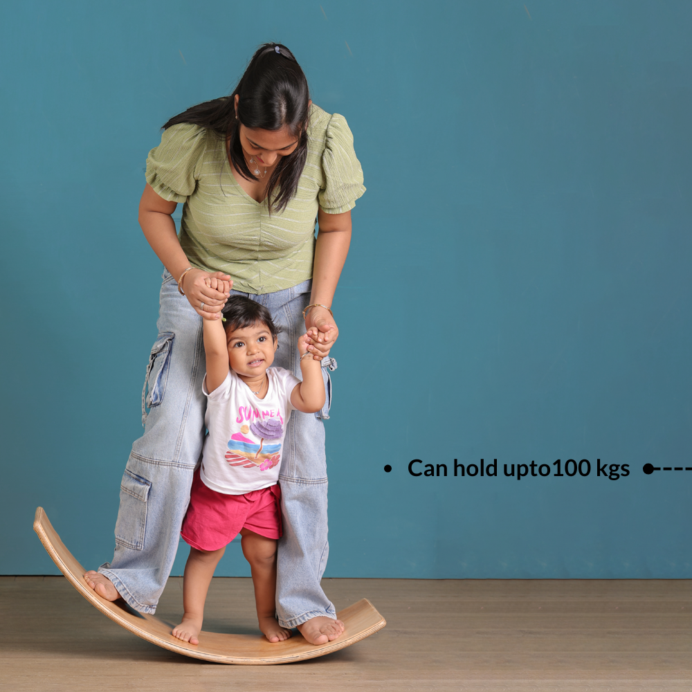 Parent and child on a balance board against a blue background