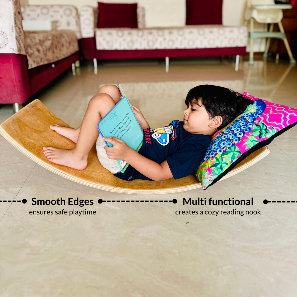 Child reading a book on a Balancing Board in a living room.