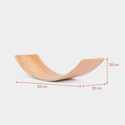 Wooden balance board with measurements on a white background