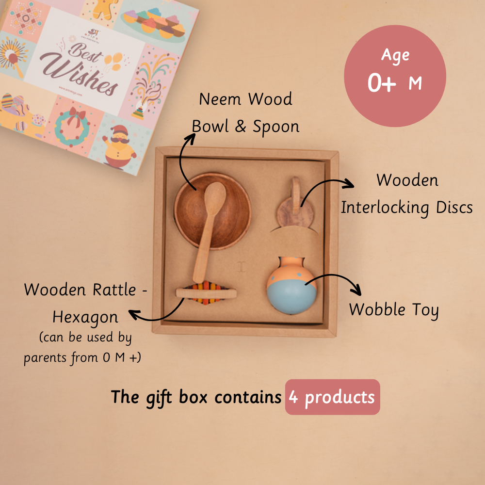 First Moments Box age box contains neem wood bowl and spoon wooden interlocking discs wobble toy wooden rattle hexagon