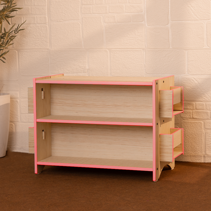 Pink Montessori toy and book shelf with child-height open storage