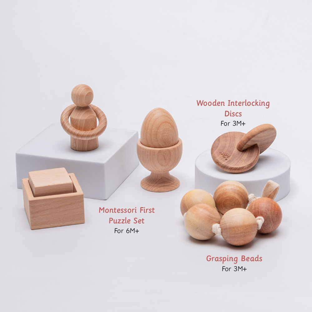 handcrafted wooden toys including grasping beads, interlocking discs, and a first puzzle – designed for sensory exploration and motor development in babies aged 3 months and up.