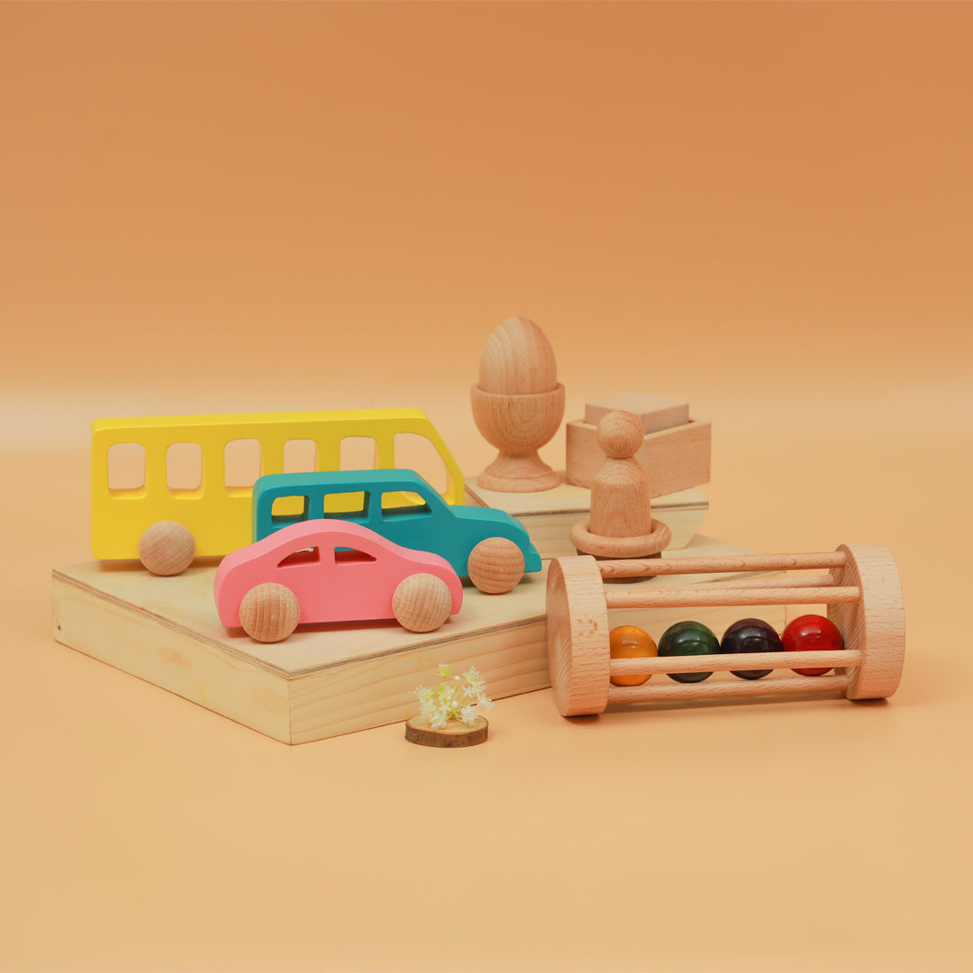 A colorful Montessori kit featuring wooden vehicles, rattles  and sensory toys for children above 6 months 
