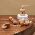 Montessori Baby Sensory Set – wooden bell rattle, interlocking discs, grasping beads, and dumbbell with rings – crafted for tactile and auditory exploration in infants aged 3 months and above.





