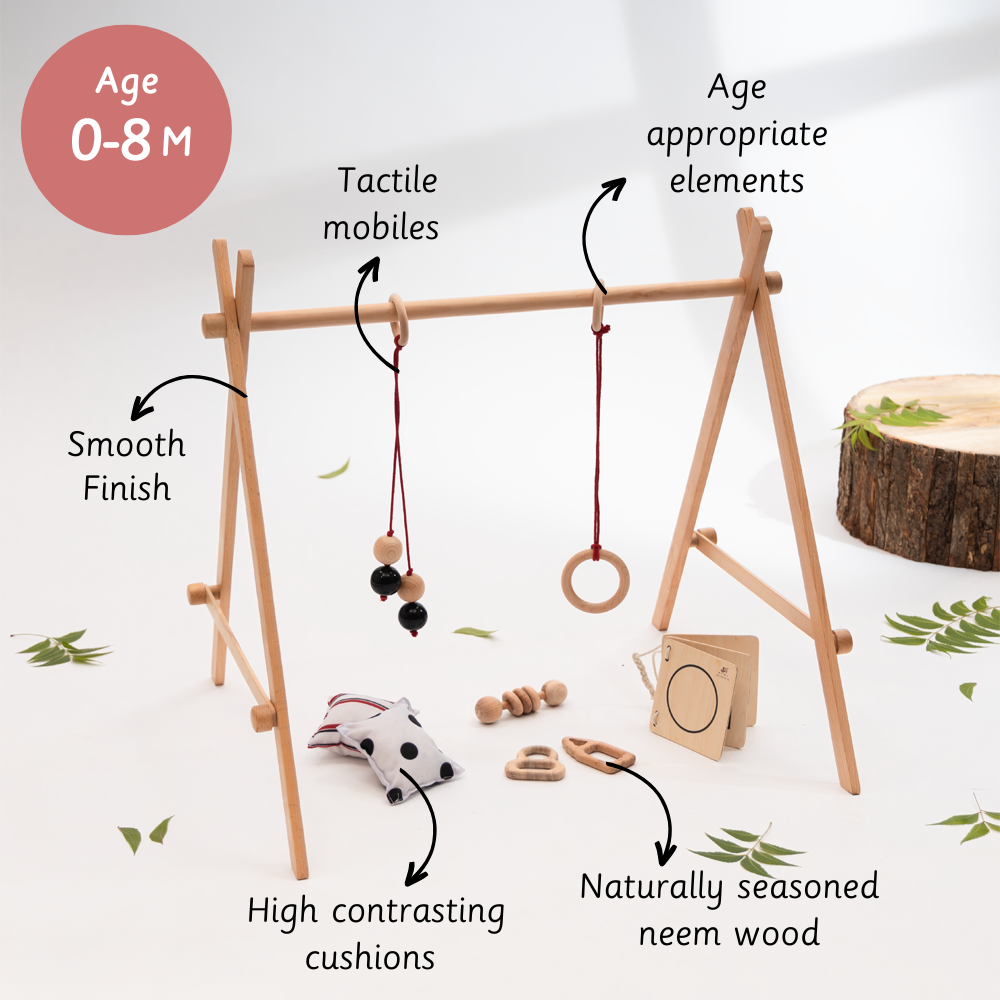 Neem Infant Starter Bundle  for 0–8 months, made from smooth, naturally seasoned neem wood and equipped with tactile mobiles, high-contrast cushions, and age-appropriate sensory elements.