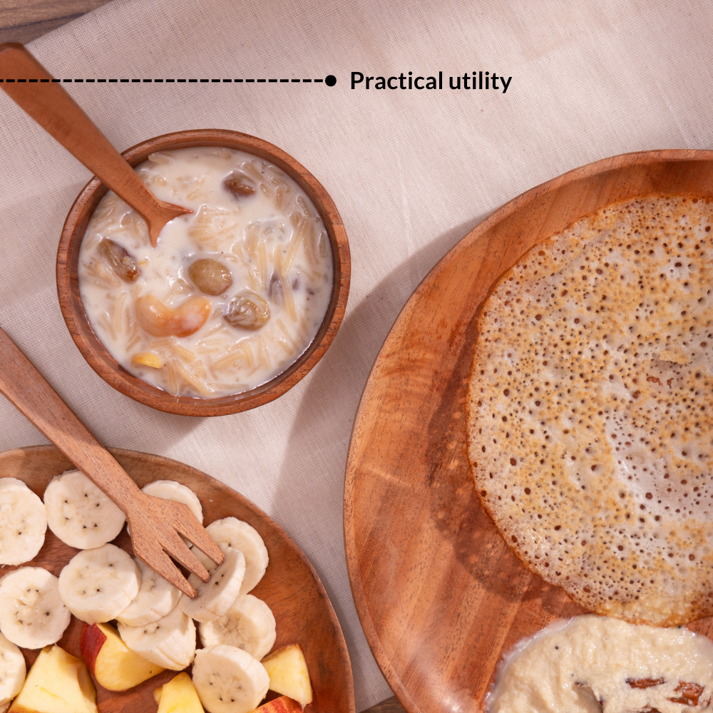 Wooden baby dinner plate and bowl with spoon and fork serving fruits and porridge for baby led weaning.
