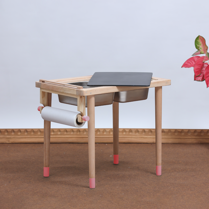 Sensory  table with pink legs  in  a plain background