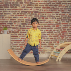  wooden Ariro balancing board, highlighting its stability, barefoot-friendly surface, and suitability for safe indoor play.