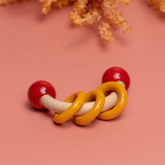 wooden baby rattle features a smooth natural wood handle, vibrant red end knobs, and three cheerful yellow rings for sensory play.
