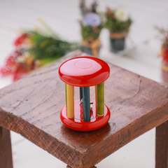 Wooden Rattle - Small Tumbler Red  with multicolored bars and a bell inside for sensory stimulation.