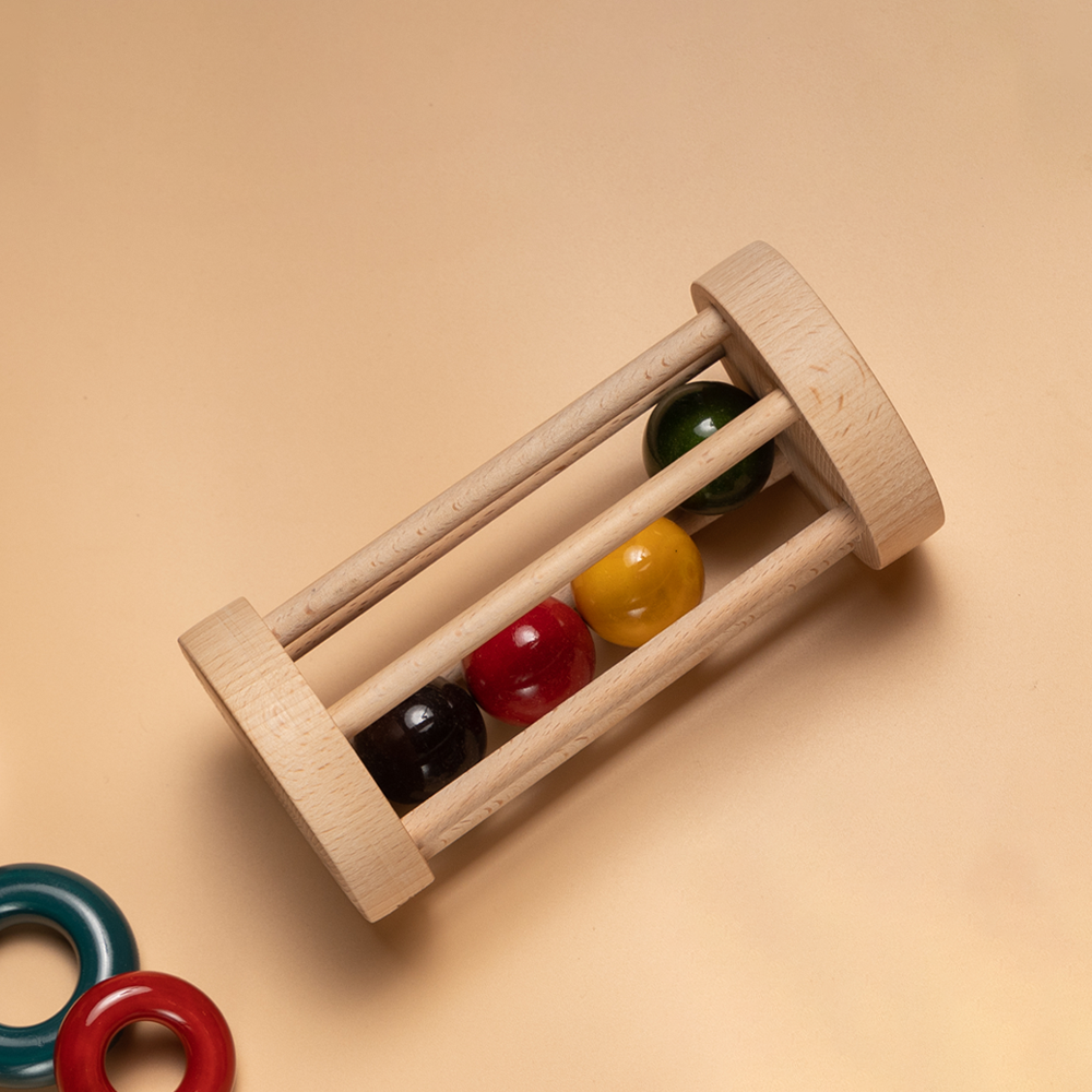 Wooden Rolling Rattle with multicolored bell inside for sensory stimulation.