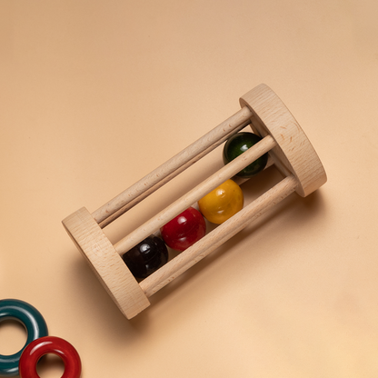 Wooden Rolling Rattle with multicolored bell inside for sensory stimulation.