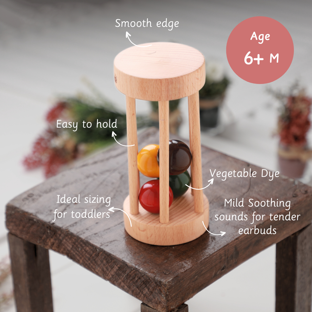 Wooden Rolling Rattle  made with vegetable dye, featuring smooth edges, easy grip, soothing sounds, and ideal sizing for babies aged 3 months and above.