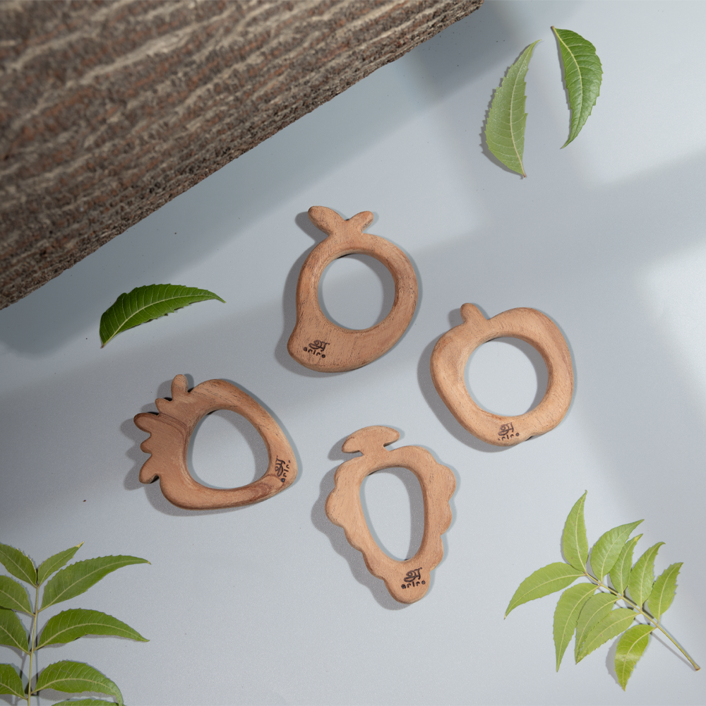  handcrafted neem wood teethers in fruit shapes, designed for babies to safely chew while benefiting from neem’s natural antibacterial properties.
