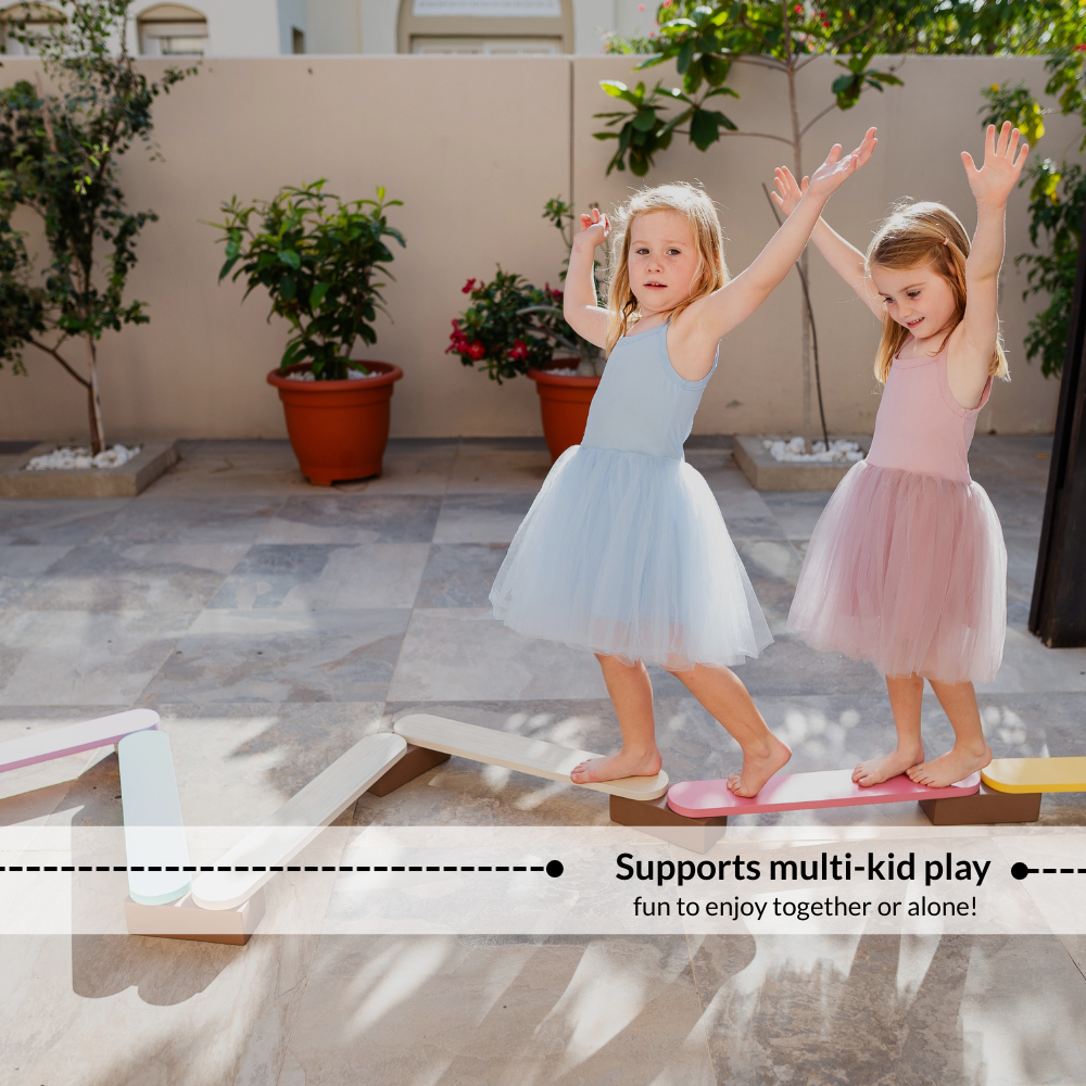 Children walking together on Ariro balancing beam promoting cooperative play, balance training and social interaction.