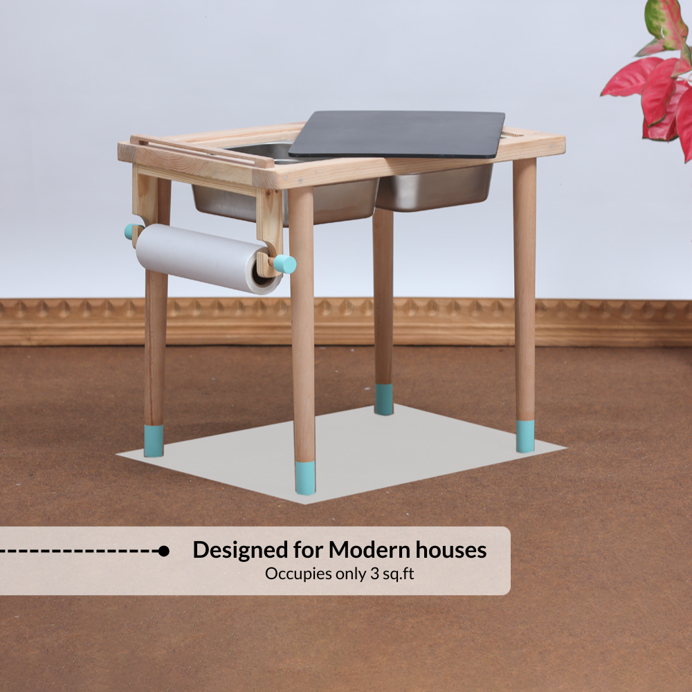 Space saving wooden Montessori sensory table designed for modern homes with built in bins, chalkboard surface and paper roll holder.