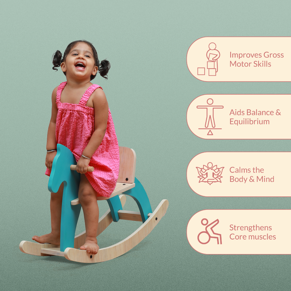 Toddler using Montessori rocking horse toy to develop gross motor skills balance coordination and core strength.