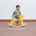 Toddler climbing on Montessori rocking horse independently supporting confidence and self initiated play.