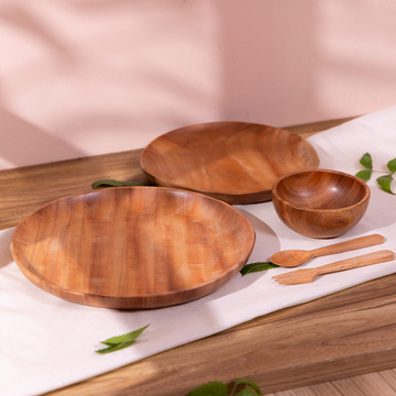 Ariro neem wood baby dinner set with large plate, small plate, bowl, spoon and fork on wooden table – Montessori baby feeding set.