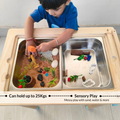 Toddler using wooden Montessori sensory table with stainless steel bins for sand, water and messy play activities that support sensory development.