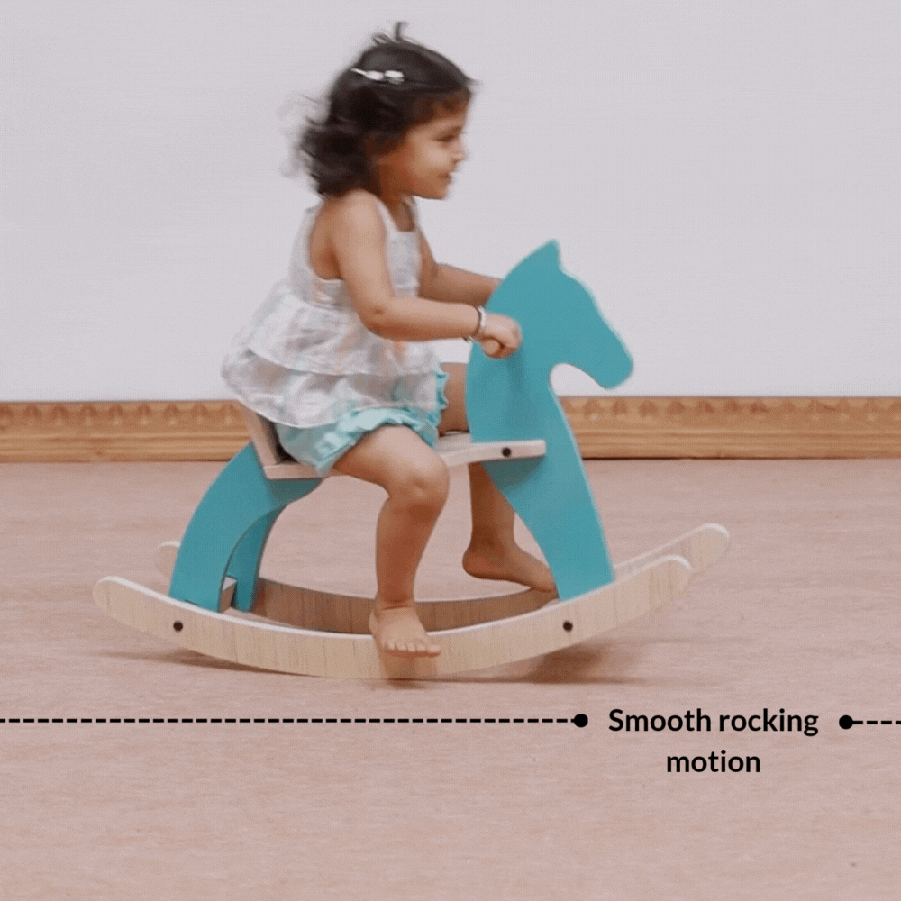 Child riding wooden rocking horse with smooth rhythmic rocking motion designed for sensory regulation.
