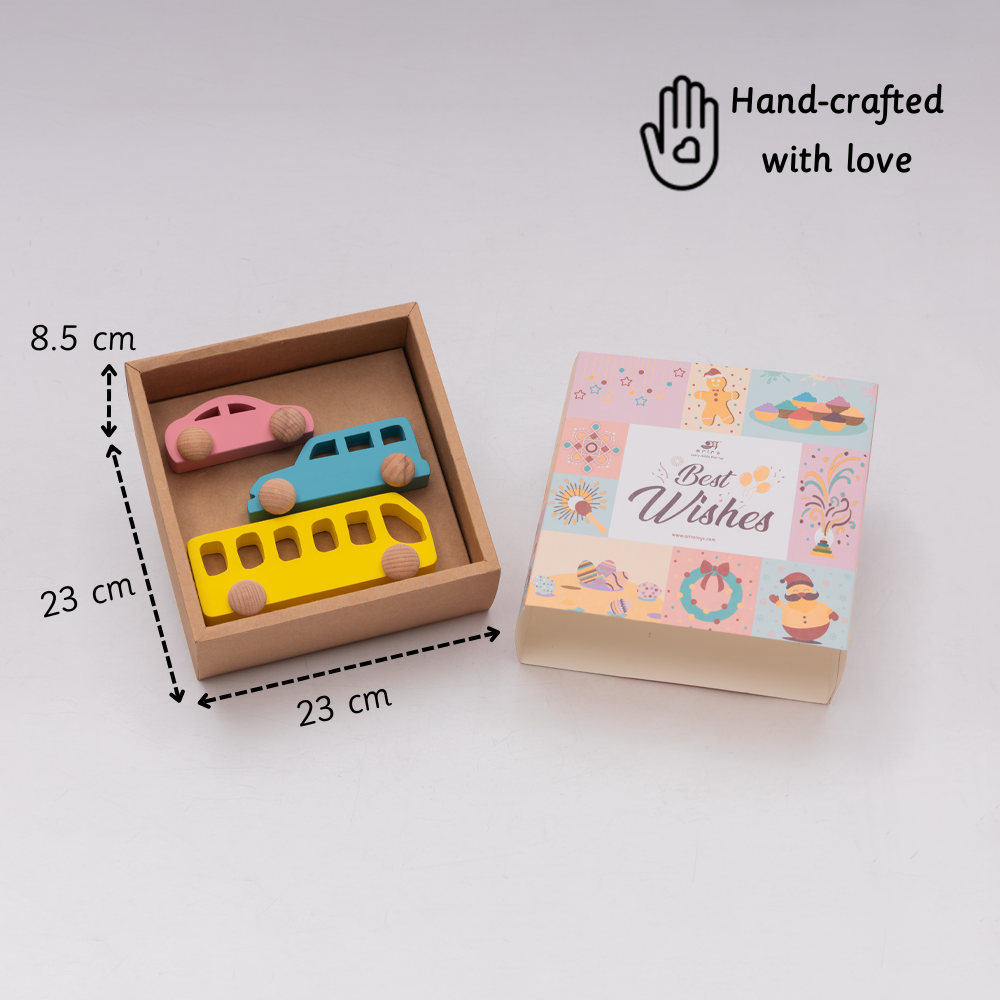 A handcrafted wooden toy vehicle set featuring a pink car, blue van, and yellow bus is neatly packed in a 23 × 23 × 8.5 cm gift box